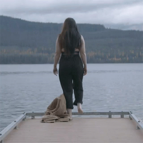 Woman Standing On Dock Looking At Water GIF