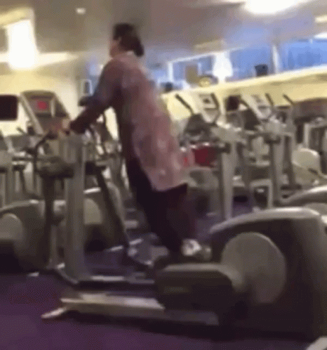 Woman Standing On Elliptical Machine GIF