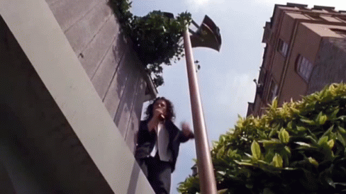 Woman Standing on Ledge Talking on Phone