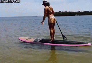 Woman Standing On Paddle Board GIF