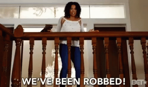 Woman Standing on Railing Saying We've Been Robbed