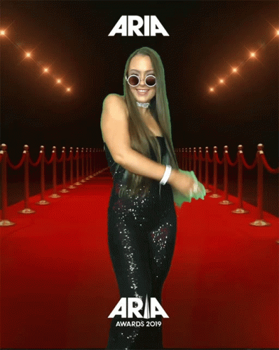 Woman Standing on Red Carpet at Aria Awards