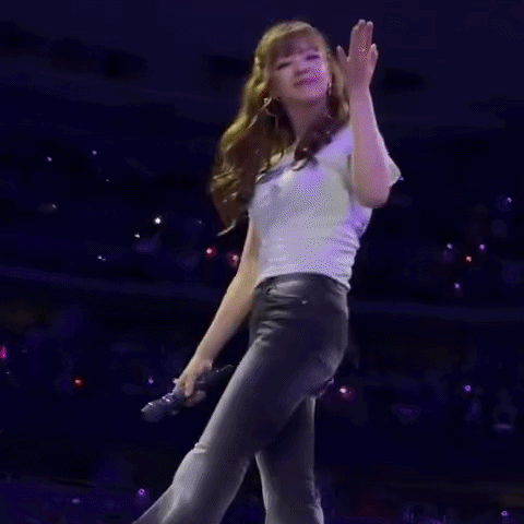 Woman Standing On Stage In Front Of Crowd GIF