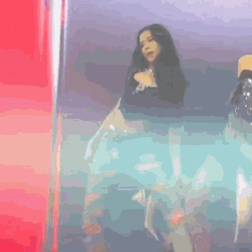 Woman Standing On Stage In Front Of Red Light GIF