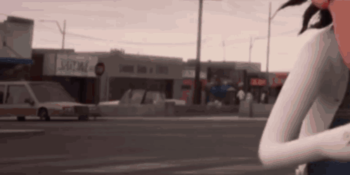 Woman Standing on Street in Front of Building