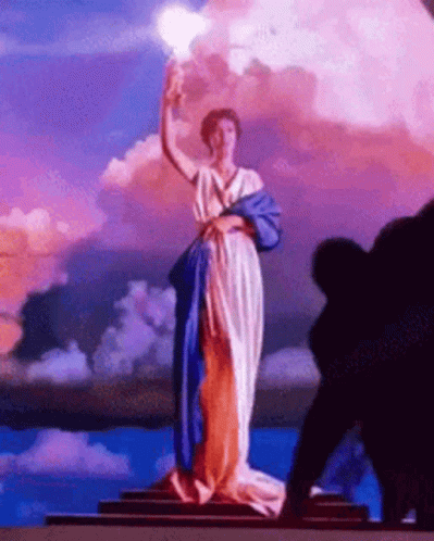 Woman Statue in Blue and White Dress Holding Torch