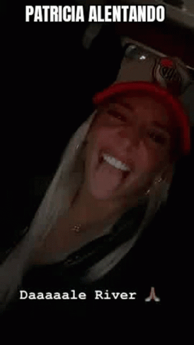 Woman Sticking Tongue Out in Red Hat