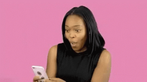 Woman Sticking Tongue Out Looking At Phone GIF