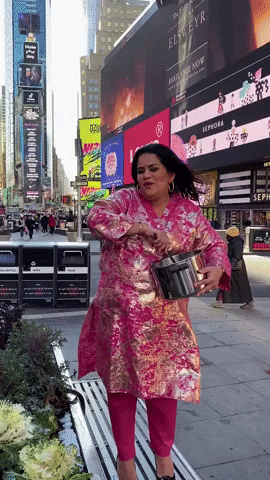 Woman Stir The Pot On Time Square Street GIF