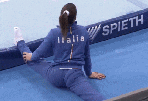 Woman Stretching Legs In Front Of Spieth Sign GIF