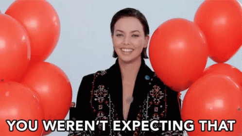 Woman Surrounded by Red Balloons Expecting