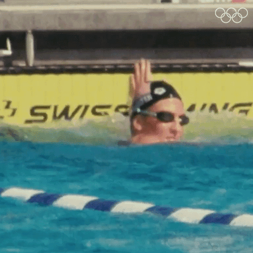 Woman Swimming in Pool With Swiss Sign