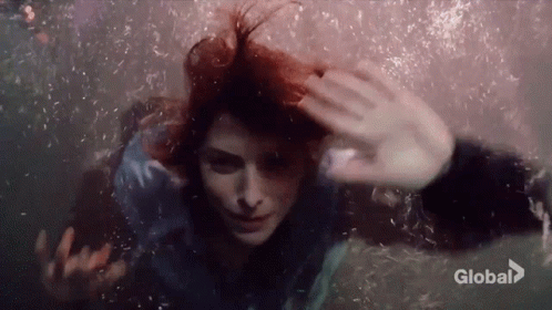 Woman Swimming Underwater Eyes Closed Bubbles From Hair