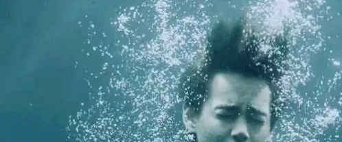 Woman Swimming Underwater Eyes Closed Bubbles From Hair