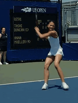 Woman Swinging Tennis Racket at Scoreboard