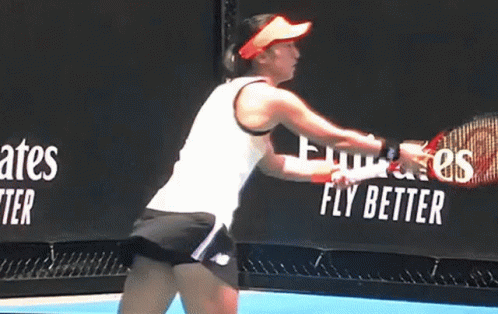 Woman Swinging Tennis Racquet