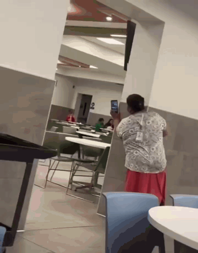 Woman Taking Photo of Child in Restaurant