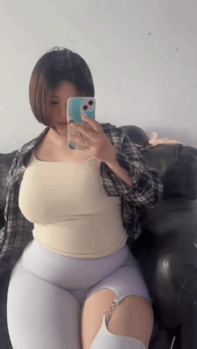 Woman Taking Picture of Herself in Mirror