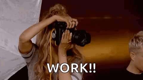Woman Taking Picture With Work Text
