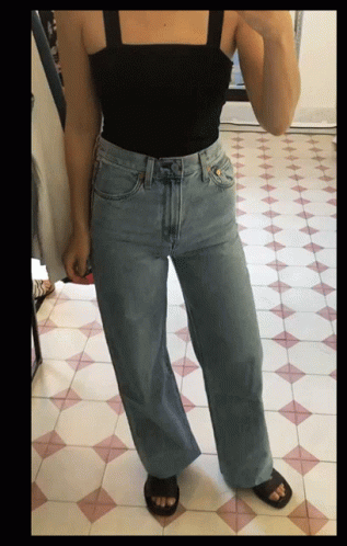 Woman Taking Selfie in Black Tank Top and Wide Leg Jeans