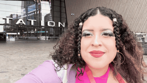 Woman Taking Selfie in Front of Station