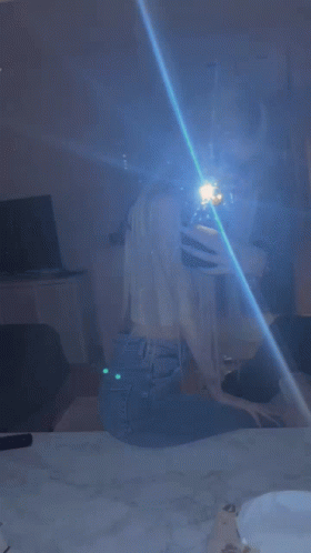 Woman Taking Selfie in Mirror With Blue Light