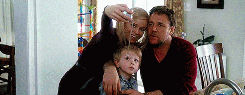 Woman Taking Selfie With Man and Child