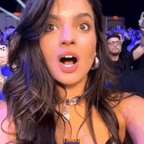 Woman Taking Selfie With Open Mouth and Crowd
