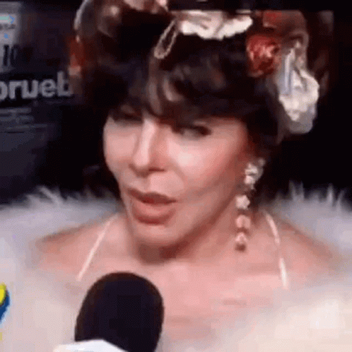 Woman Talking Into Microphone With Flower Crown