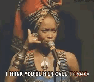 Woman Talking Into Microphone With Head Scarf and Bracelets