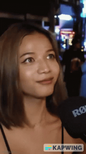 Woman Talking Into Rode Microphone Saying Kapwing