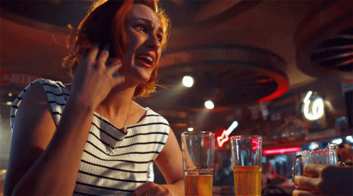 Woman Talking on Cell Phone at Bar