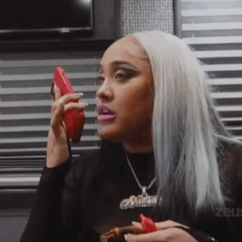 Woman Talking on Cell Phone Holding Cigar