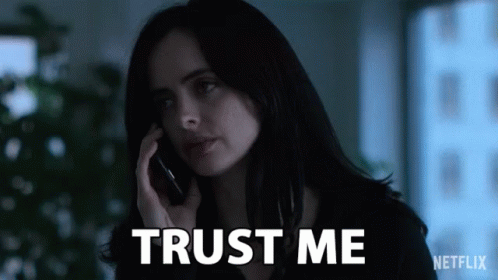 Woman Talking on Cell Phone With Trust Me Behind Her