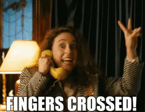 Woman Talking On Phone Fingers Crossed GIF