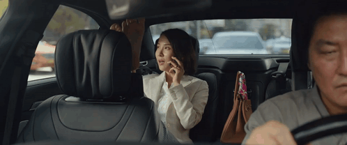 Woman Talking On Phone In Back Seat GIF