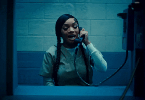 Woman Talking On Phone In Prison GIF