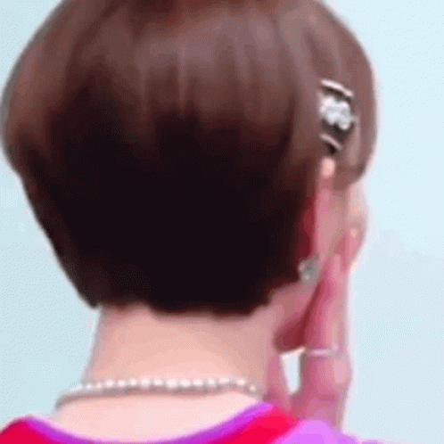 Woman Talking On Phone With Earrings And Necklace GIF