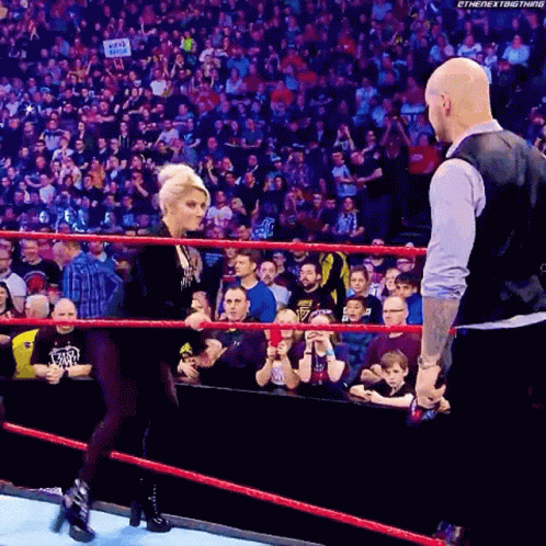 Woman Talking To Bald Man In Wrestling Ring GIF