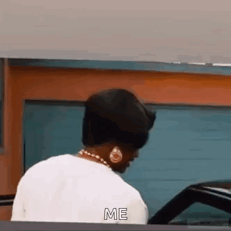 Woman Talking to Car in Front of Garage