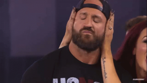 Woman Touching Man's Ear With Subscribe Tattoo