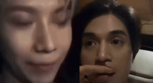 Woman Touching Man's Nose Sitting Together