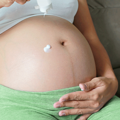 Woman Using Ointment For Pregnant Belly GIF