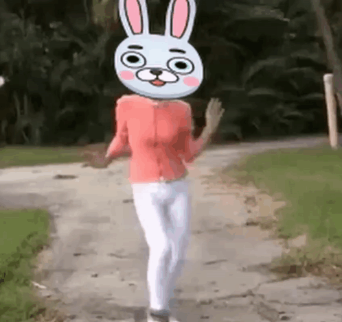 Woman Walking Down Dirt Road With Bunny Head GIF