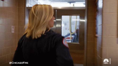 Woman Walking Down Hallway With Chicago Fire