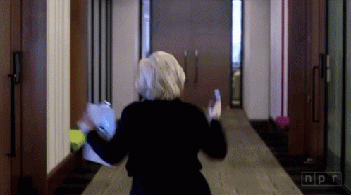 Woman Walking Down Hallway with NPR