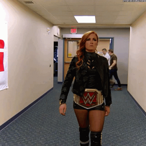 Woman Walking Down Hallway With W Belt
