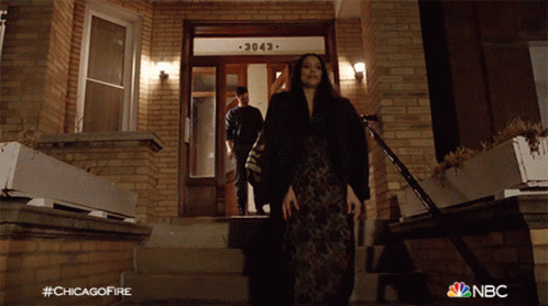 Woman Walking Down Stairs at Brick Building 3083