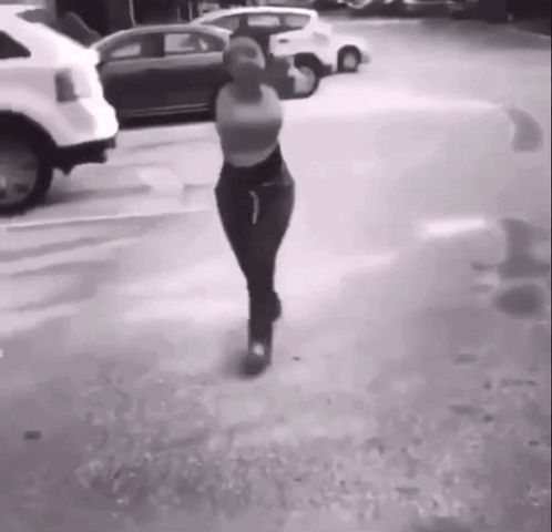 Woman Walking in Parking Lot