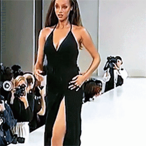 Woman Walking Runway in Black Dress